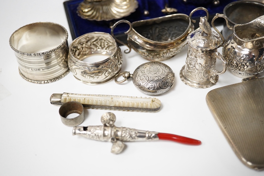 A collection of mainly small silver items including a George V posy vase, mother of pearl handled fruit knife, sovereign case, cream jug, tortoiseshell and silver trinket box (a.f.), continental miniature white metal tan